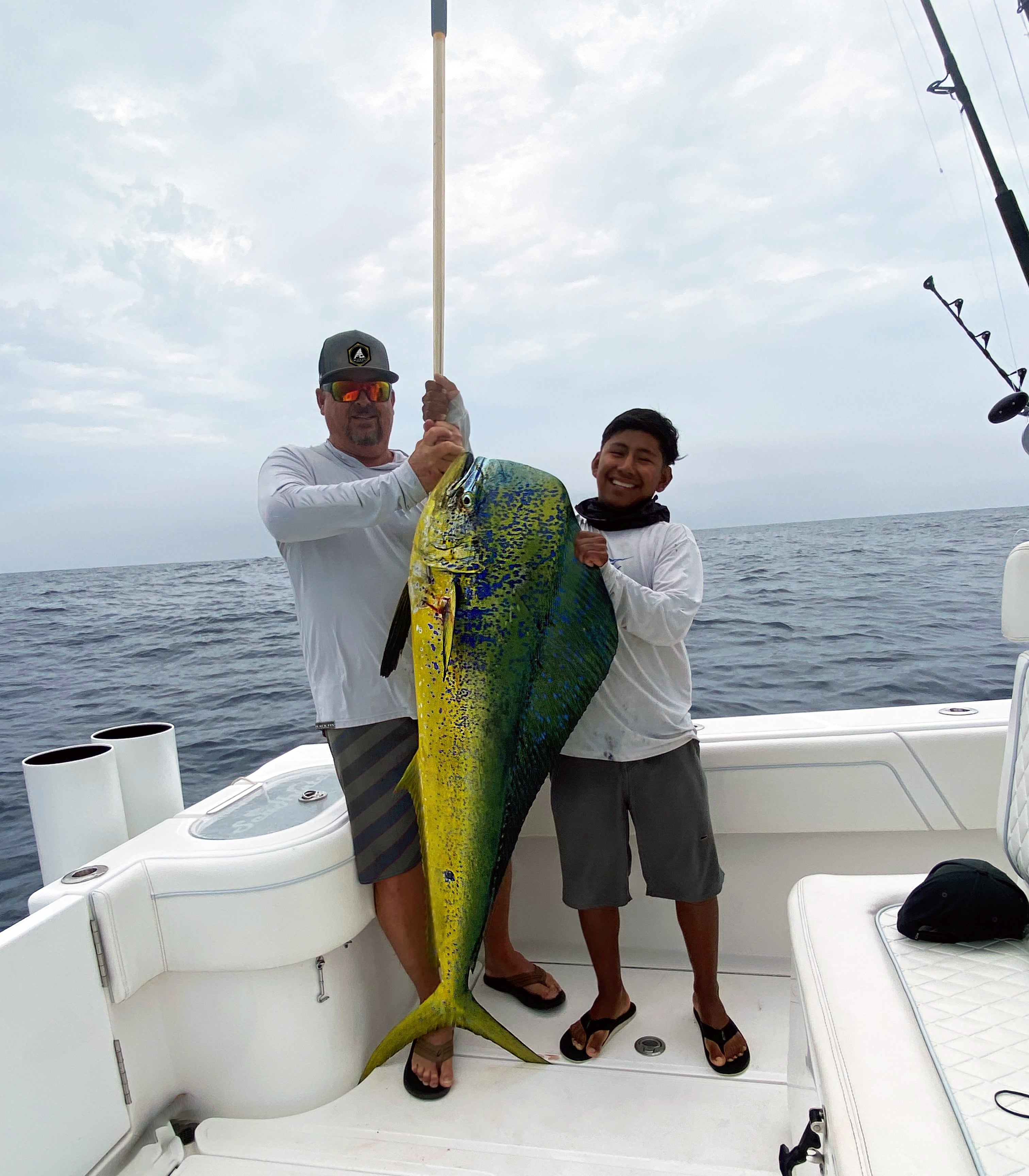 Two people holding up a fish